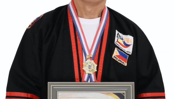 UPV PE prof receives International Modern Arnis Black Belt Recognition during IMAFP and MATTI Gathering